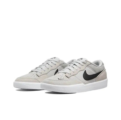 Light grey low-top skate shoe with black swoosh and white midsole
