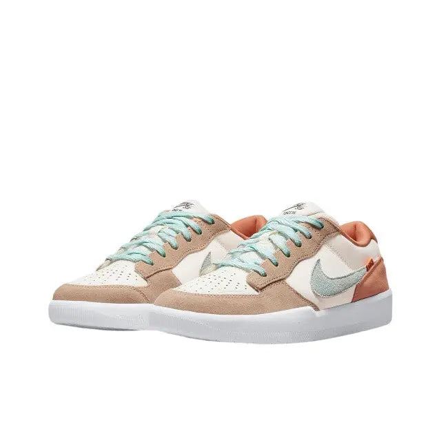Nike SB low-top sneaker side view in tan and cream with mint laces and swoosh.
