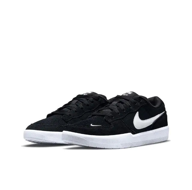 Black low-top skate shoes with white Swoosh and white outsole