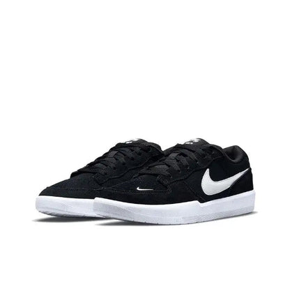 Black low-top skate shoes with white Swoosh and white outsole
