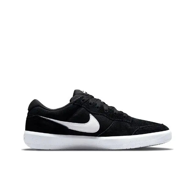 Black low-top skate shoe side view with white Swoosh and midsole