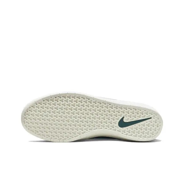 Green outsole with textured tread and Nike logo on the bottom