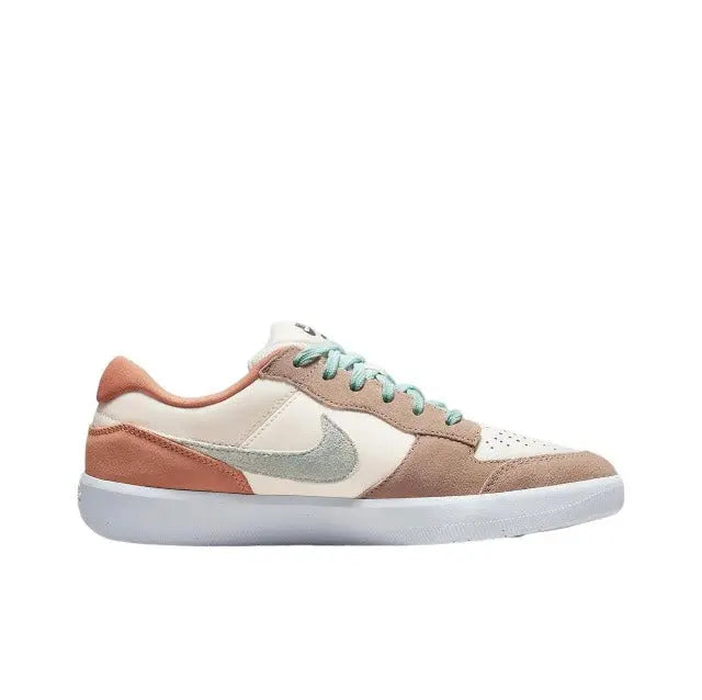 Nike SB low-top sneaker profile view with rust side panel, cream base, mint laces.