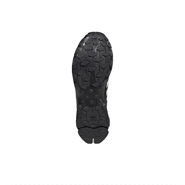Shoe outsole with textured tread, dark black rubber