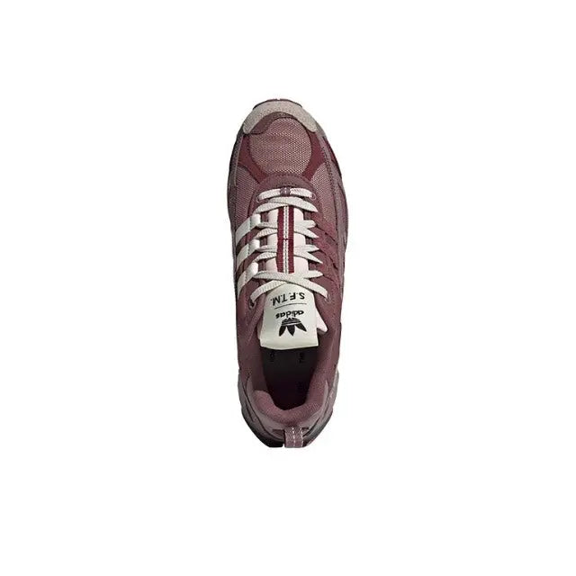 Adidas low-top sneaker in maroon with white laces and patterned tongue label