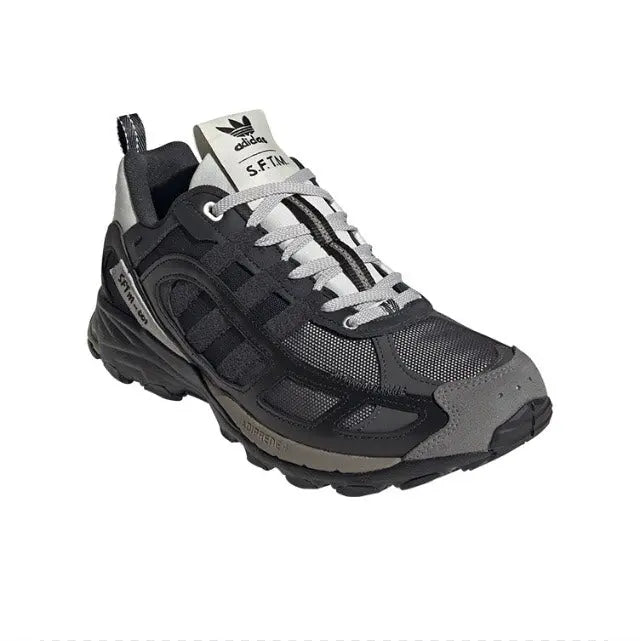 Trail sneaker with black upper, light gray laces, and cushioned dark midsole