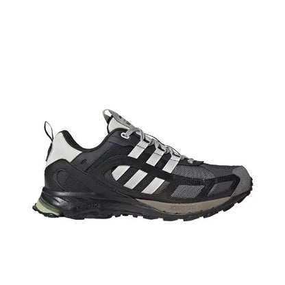 Running sneaker with black upper, white stripe panel, and light green outsole detail