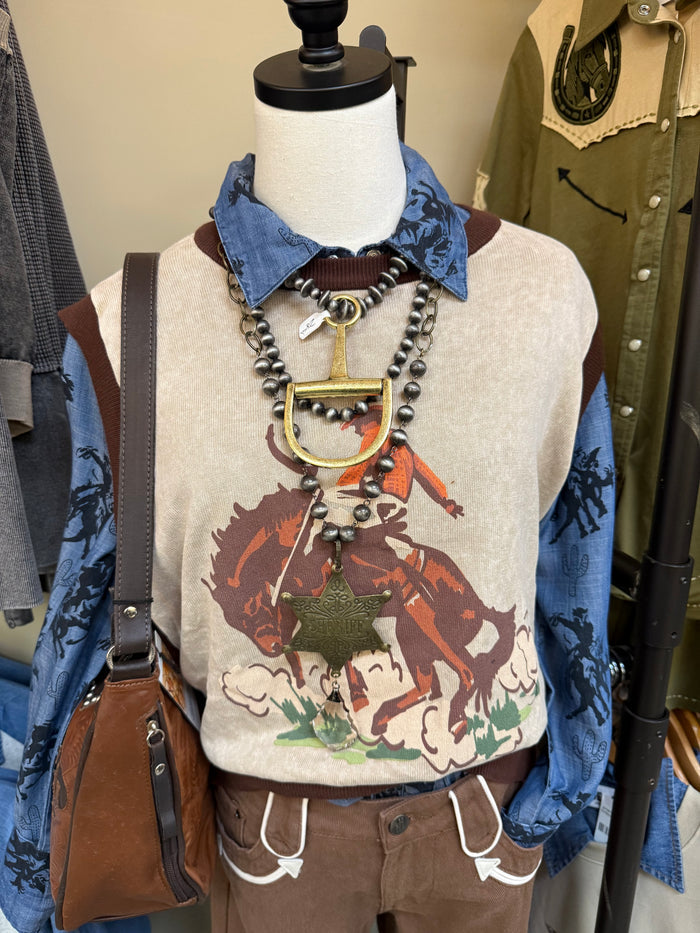 Bronc sweater vest on mannequin with western horse print, sleeveless knit and layered necklaces