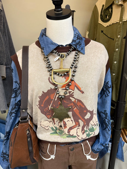 Bronc sweater vest on mannequin with western horse print, sleeveless knit and layered necklaces