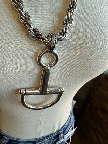 Silver snaffle bit charm necklace with circular ring top and braided chain