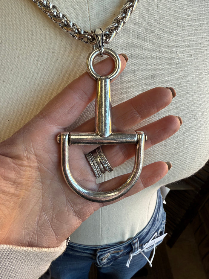 Silver chain necklace with braided links and snaffle bit pendant