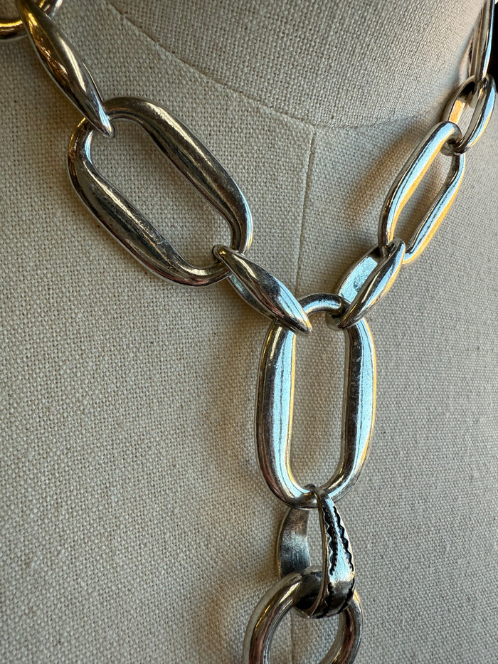 Silver-tone chain necklace with large oval links and center U-shaped bit charm