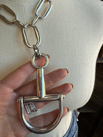 Silver-tone open-link chain necklace with hanging U-shaped bit charm and small rings
