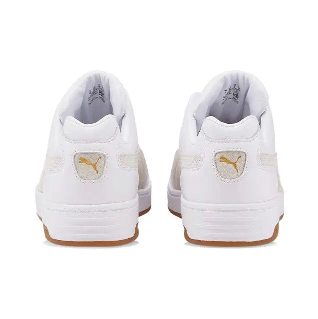 White Puma low-top sneakers with heel branding and gum outsole