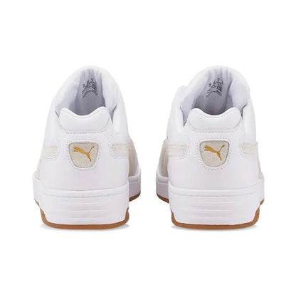 White Puma low-top sneakers with heel branding and gum outsole
