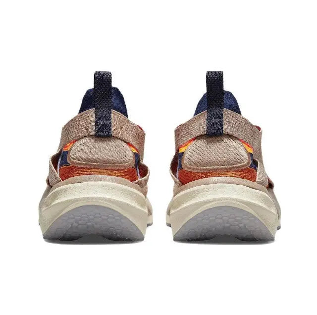 Back view of knit sneaker with navy heel strap and cream midsole