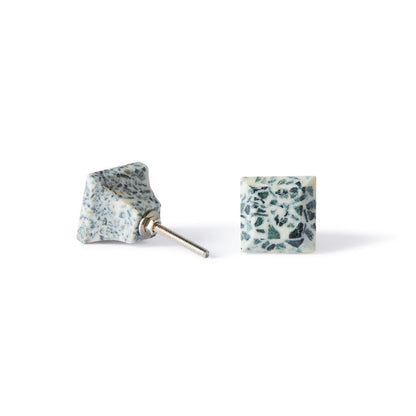A pair of Speckle Square Knob 3.5cm earrings with a blue and white terrazzo look—one lays flat, the other stands upright to show the metal post, ideal for fans of colorful cabinet hardware-inspired style.