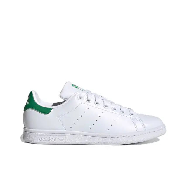 White leather sneakers with green heel detail and perforated toe