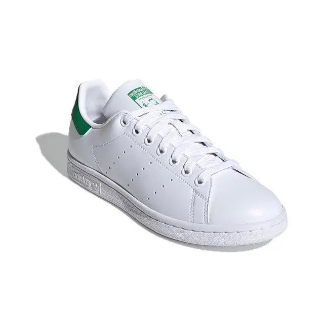 White leather low-top sneakers with green collar and lace-up front