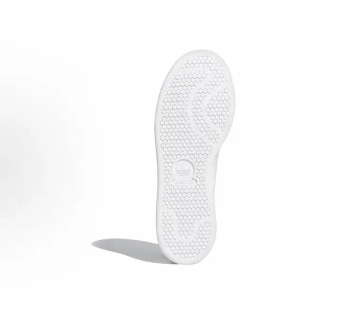 Adidas Stan Smith sneaker outsole, textured tread on white rubber sole