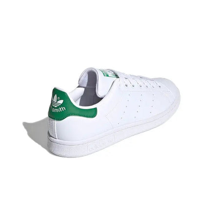 White leather low-top sneakers from heel view with green tab