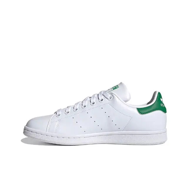 White leather sneakers with green-trim collar and perforated toe