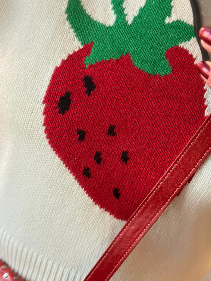 Cream short-sleeve sweater with red strawberry knit graphic and green leaves