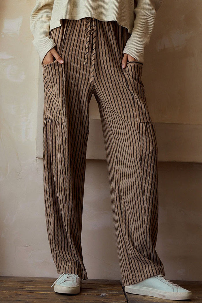 Brown striped cargo pants with side pockets, relaxed straight-leg fit.