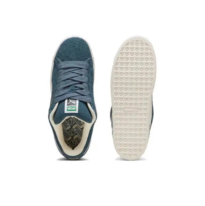 Puma suede sneakers with dark blue laces; white outsole view