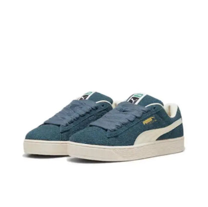 Puma suede sneakers, two shoes side-by-side in dark blue with white stripe
