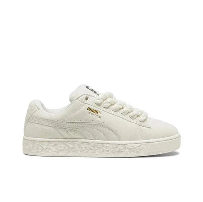 Puma suede low-top sneaker in light beige with lace-up front, Puma stripe, and white sole