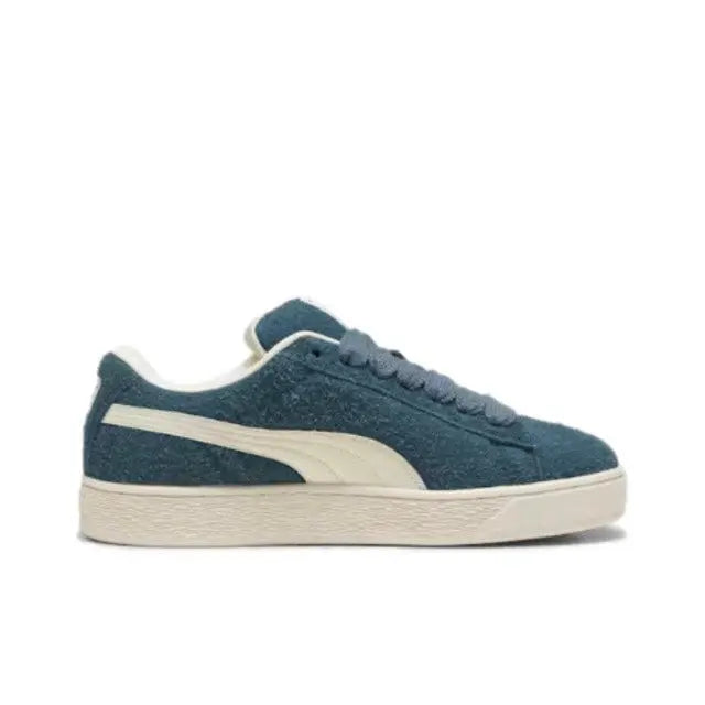 Puma suede sneakers side profile, dark blue suede with white stripe and sole