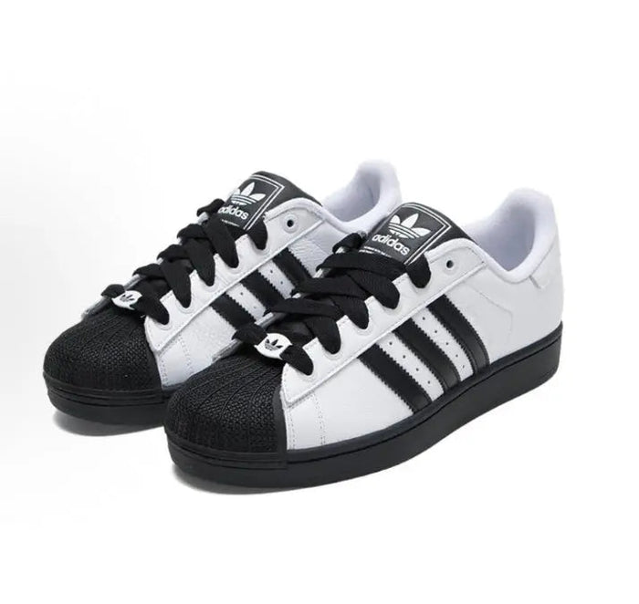 Adidas Superstar II sneaker pair in white with black toe cap, three stripes, lace-up
