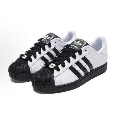Adidas Superstar II sneaker pair in white with black toe cap, three stripes, lace-up