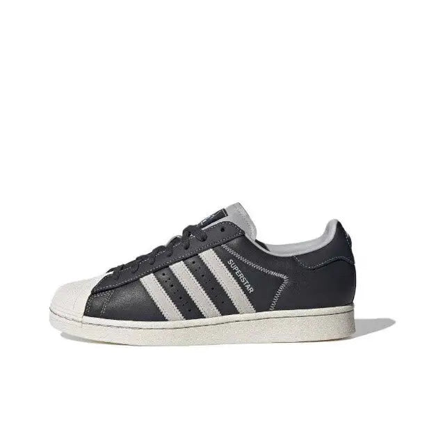 Adidas Superstar low-top sneakers in dark carbon with white triple stripes and shell toe