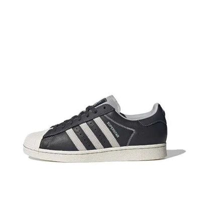 Adidas Superstar low-top sneakers in dark carbon with white triple stripes and shell toe
