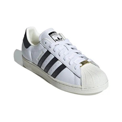 Adidas Superstar sneakers, white leather with black stripes and gold heel detail