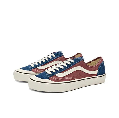 Pair of low-top lace-up sneakers with maroon uppers, navy sides, cream wavy stripe, white sole