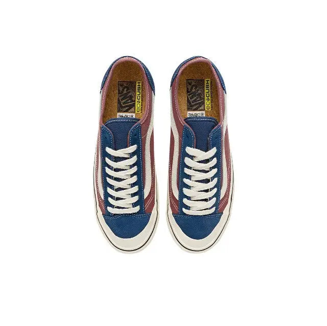 Low-top sneakers with white laces, maroon canvas uppers, navy side panels, cream toe cap