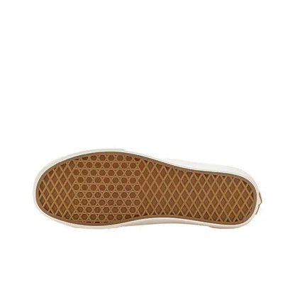 Rubber outsole with tan gum tread and white edge from low-top sneakers