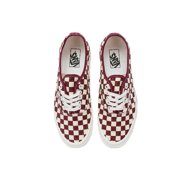 Pair of low-top checkerboard canvas sneakers with white laces and burgundy lining