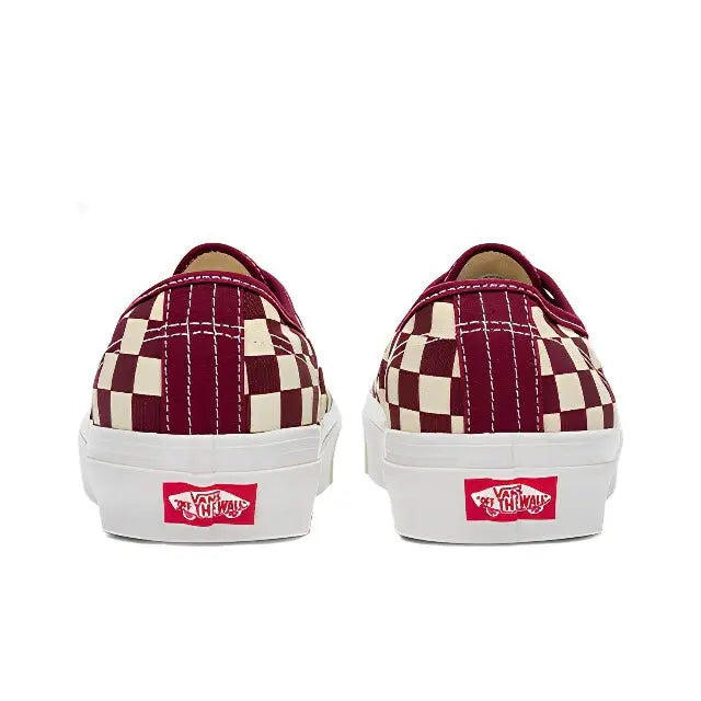 Back view of low-top checkerboard canvas sneakers with heel Vans patch and white sole
