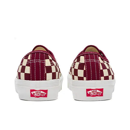 Back view of low-top checkerboard canvas sneakers with heel Vans patch and white sole