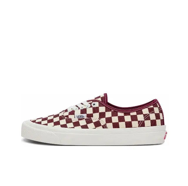 Low-top checkerboard canvas sneaker with Vans tag, white laces, and white rubber sole