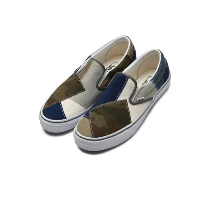 Slip-on sneakers angled, patchwork camo uppers in olive, navy, and cream with white sole