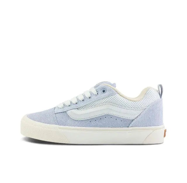 Knu Skool low-top sneaker in light blue and off-white, side view with lace-up