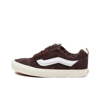 Brown low-top sneakers with white side stripe and cushioned sole