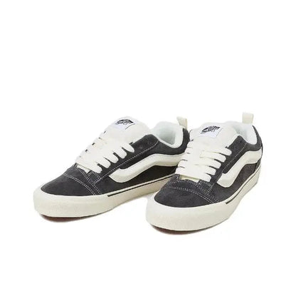 Vans Knu Skool low-top sneakers, pair view; dark upper with white laces and side stripe