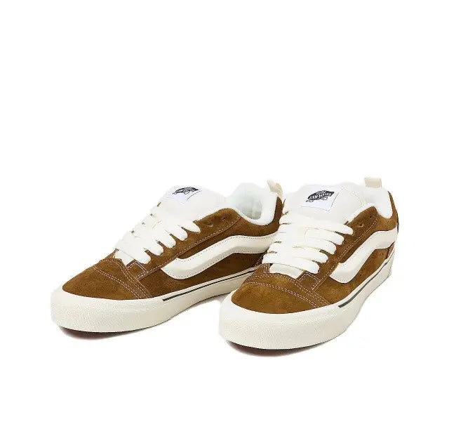 Brown and white Knu Skool low-top sneakers, front view with white laces