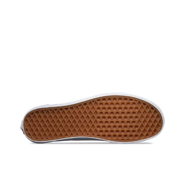 Brown rubber outsole with diamond tread and white sidewall edge on low-top sneaker